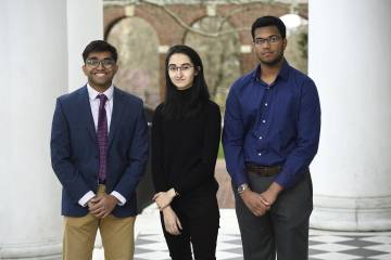 Three students pose for a photo