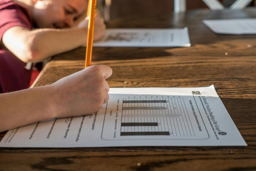 A closeup of a student putting a pencil to paper
