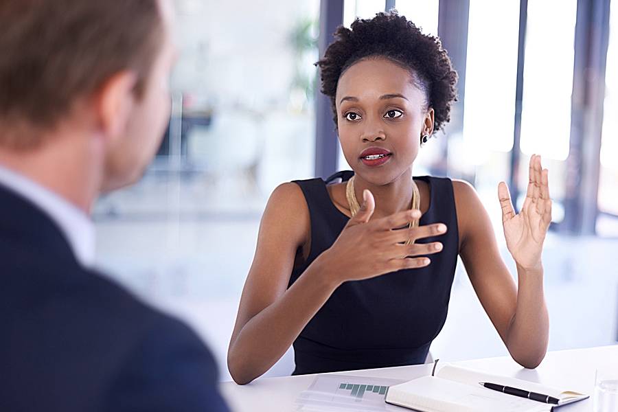 Businesswoman talking to a male employee
